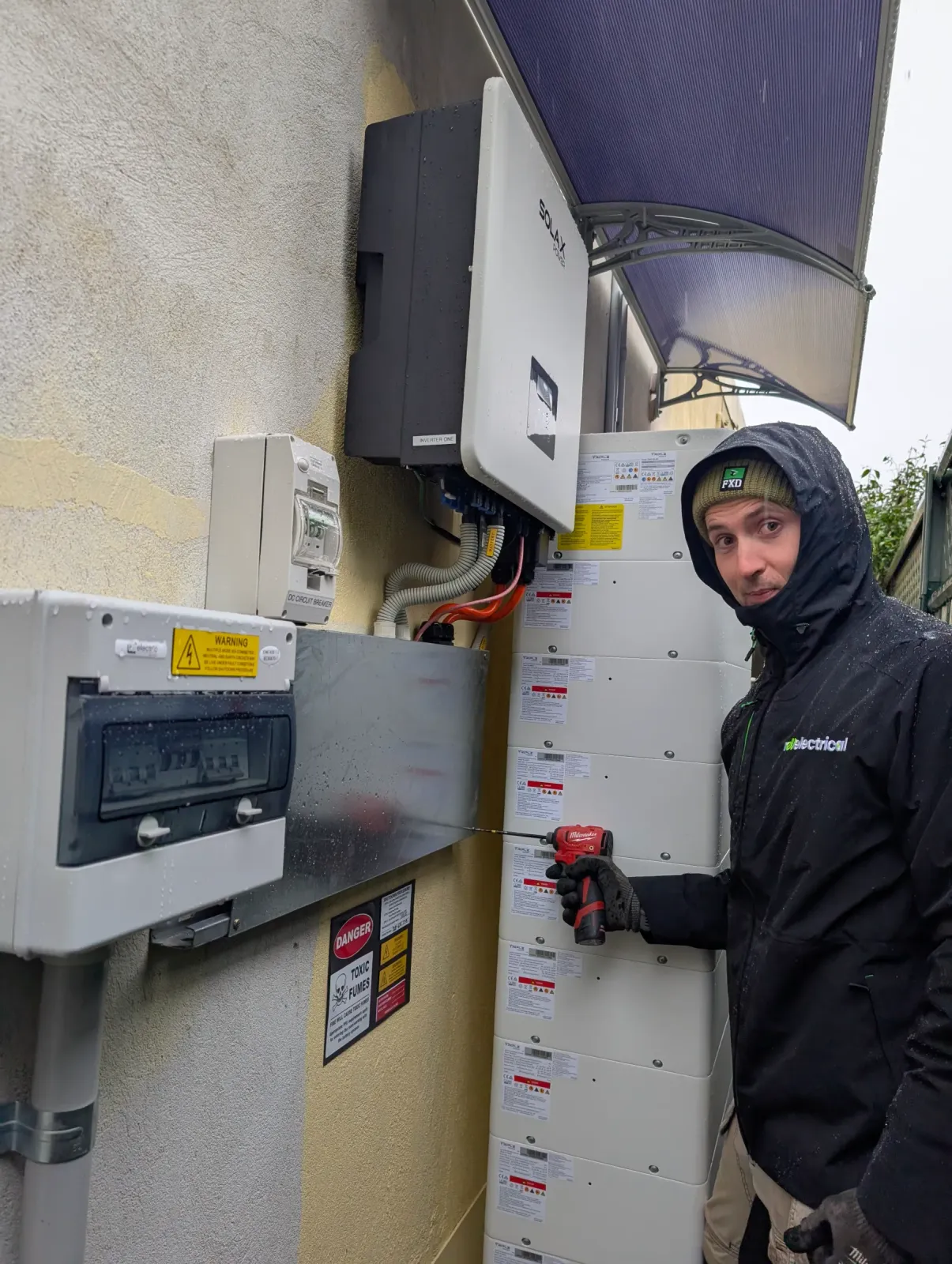 One of our electricians tying a battery into the switchboard