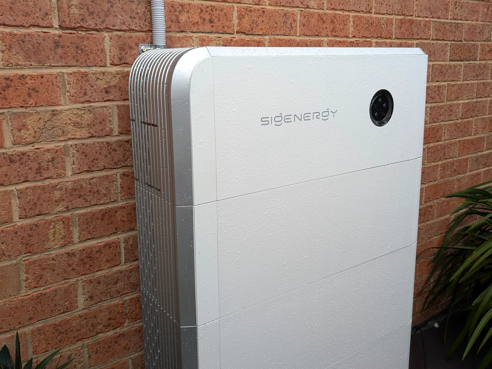 A Sigenergy SigenStor stack installed outdoors beside the meter