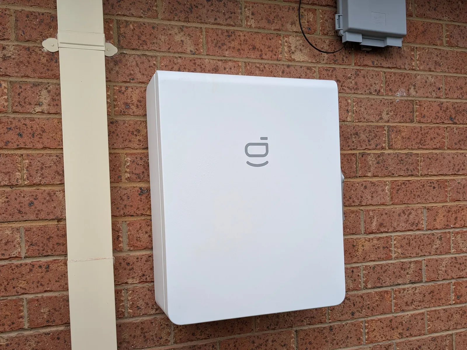A wall-mounted Sigenergy unit sited under the eave