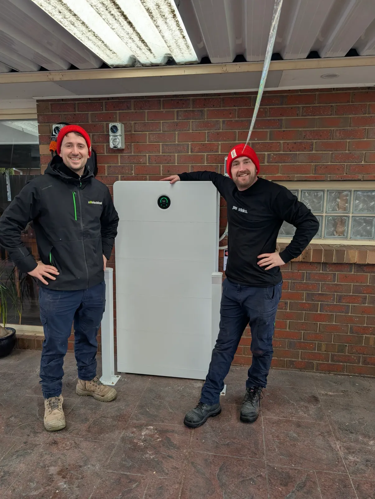 Two of our electricians beside a finished battery install