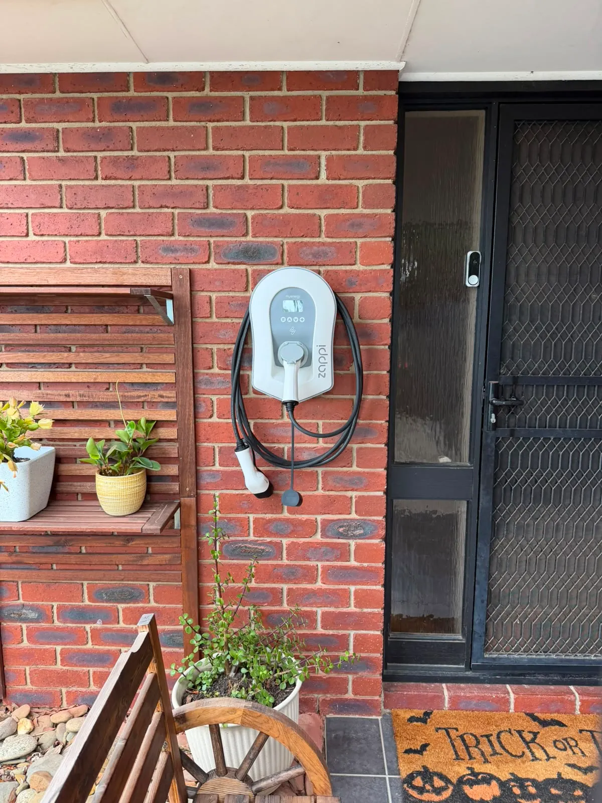 Zappi on the front of the house, cable holstered